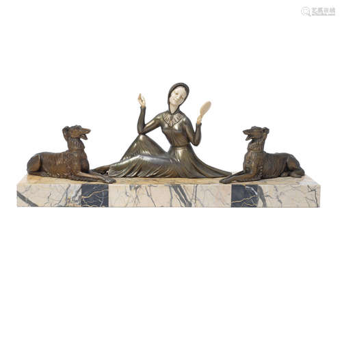 SIGNED IN CAST, CIRCA 1925 an art deco patinated metal and ivorine study of a seated female with dogs by Molins