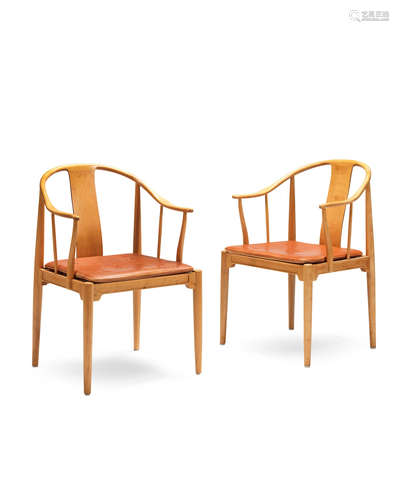 solid cherry, buttoned leather  Hans Wegner (Danish, 1914-2007) : A pair of 'China' chairs, model FH 4283, designed 1966, manufactured by Fritz Hansen, 1980's