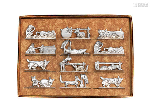 SIGNED IN CAST, CIRCA 1925  a boxed set of twelve plated metal animalier knife rests by Benjamin Rabier