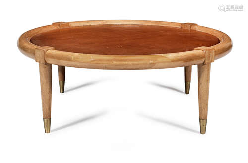 American walnut, thick tan leather, brass, 96cm diameter x 36.5cm high  T.H Robsjohn-Gibbings, A low table, c.1950's, manufactured by Widdicomb Furniture Company, Grand Rapids, Michigan