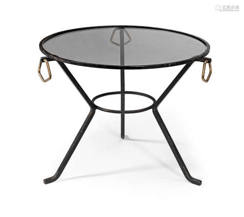 Iron frame with angular brass handles, glass, 59cm diameter x 45cm high  Attributed to Jacques Adnet (French 1900-1984) An occasional table