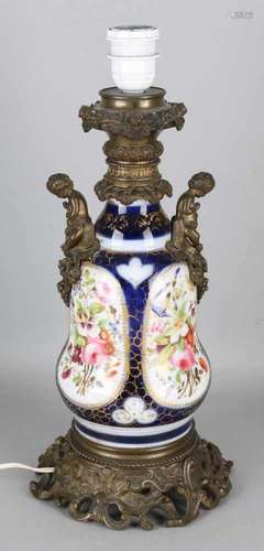 Antique French porcelain lamp base with hand-painted floral decors and two putti's. Circa 1880.