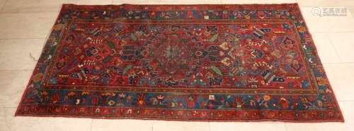 Old / antique Persian rug with colorful floral decors. Slightly worn. Size: 187 x 104 cm. In good