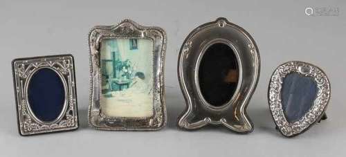 Four silver photo frames in various shapes and velvet backs. various levels. 6.5x8cm-9x12cm. In