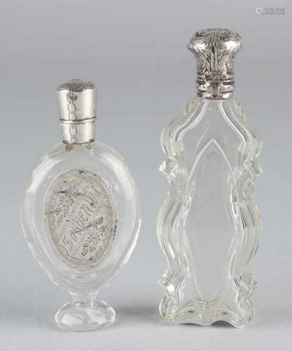 Two odeurflacones with silver, 835/000, elongated circled crystal bottle with silver cap and