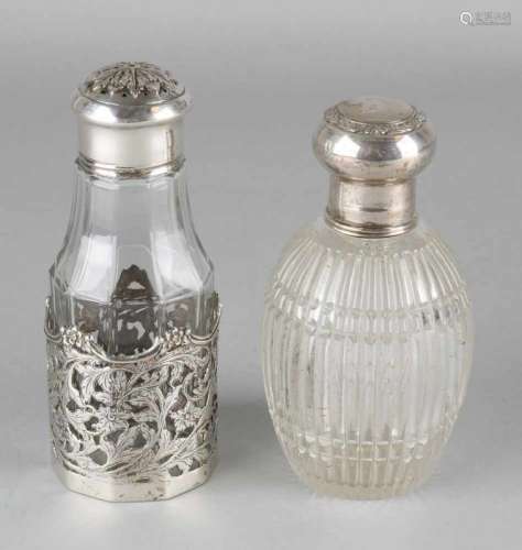 Two vials with silver holder and cap. Silver bottle of ribbed glass with silver collar and cap