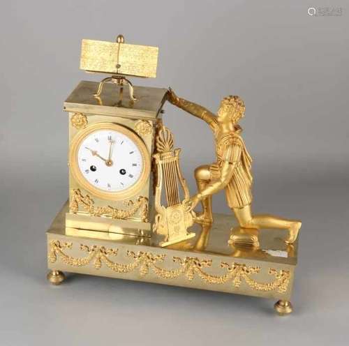 Antique French fire-gilt bronze Empire pendulum. Circa 1800. Man with lyra and music sheet.