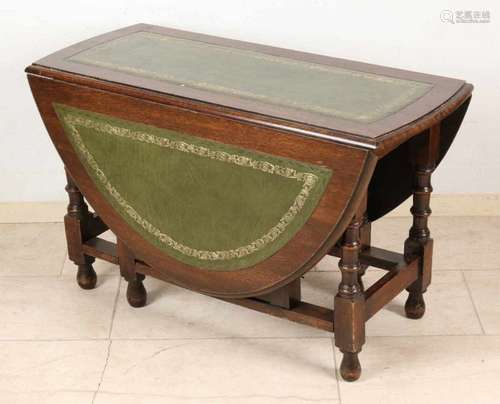 Antique low English oak wooden hanging table with green leather on top. Circa 1900. Nice table!