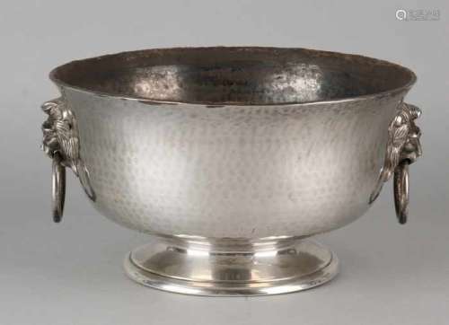 Large silver bowl, 835/000, round model with hammer blow on round base. Equipped with two carrying