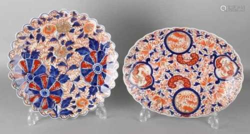 Two separate 19th century Imari porcelain plates with scalloped rim and flower decors. One