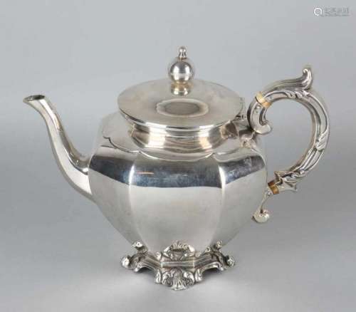 Silver teapot, 833/000, octagonal placed on a square worked foot with curling legs. Equipped with