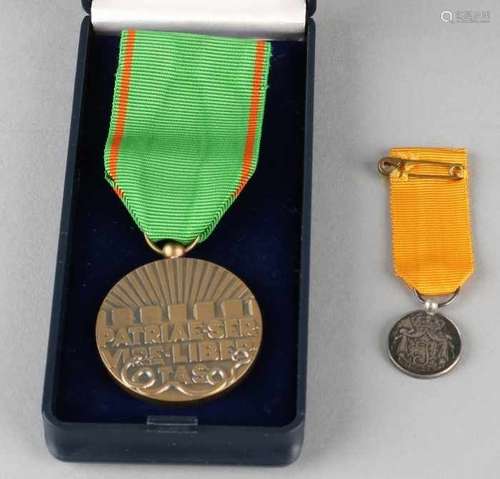 Two Dutch medals. One medal for public order and safety. One silver medal for long-term loyalty