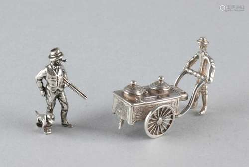 Two silver miniatures. Hunter with pipe and ice cream man with handcart, with rotating wheels. MT .: