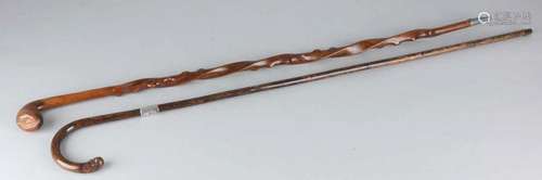 Two antique walking sticks. Once with silver ring. Circa 1900. Size: 87 - 88 cm. In good