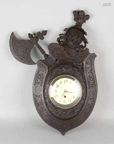 German historicism wall clock with shield, armor and ax. One ax is missing. Circa 1880. With