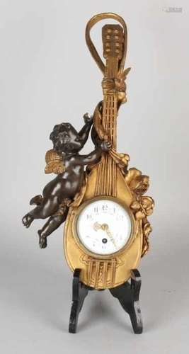 19th Century gilt bronze wall clock. Circa 1870. Putti with mandolin. Eight day still clockwork.