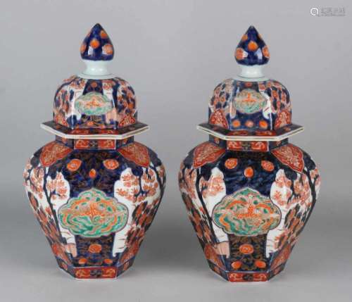Two beautiful six-sided 19th century Imari porcelain lid vases with gold and floral decors. Soil