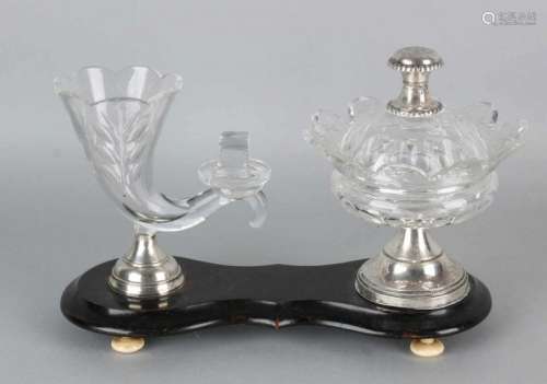 Crystal table set with silver, 833/000, on wooden base. Aculade shaped basement with a crystal