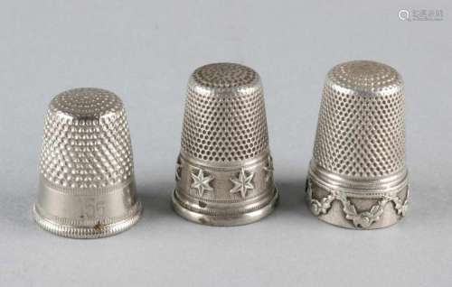 Three thimbles, 2 silver models with garlands and stars and a steel thimble. about 2 cm. In good