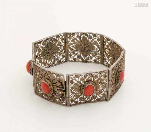 Bracelet made of white metal, made from filigree with oval cabouchon cut red coral. Width 27 mm.