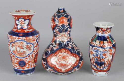 Three times 19th century Imari porcelain, floral + gold decor. Consisting of: Rare cusp vase, two