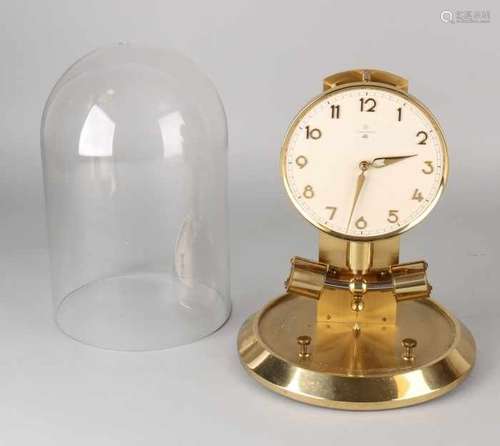 German Junghans Ato electro mechanical clock. Brass with a glass dome. Battery holder is missing.