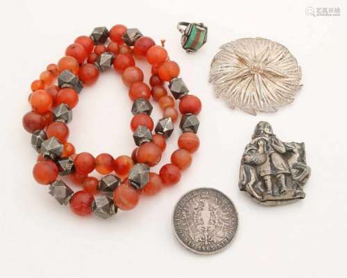 Set of silver jewelry with a filigree brooch, a ring with jade and goldstone, a coin and pendant and