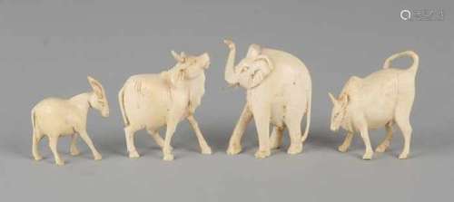 Four antique ivory animals. Circa 1920. Consisting of: Two buffalo, elephant and goat. Size: 4 - 5