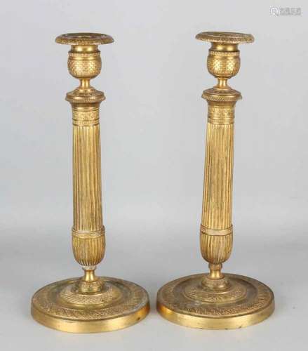 Two large fire-gilt bronze Empire candlesticks. Circa 1820. Size: 32 x 13 cm ø. In good condition.