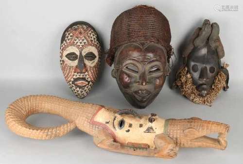 Four old African carved masks. Among others: Congo, polychrome, Kuba Ngaady mask. Mask Nigeria,