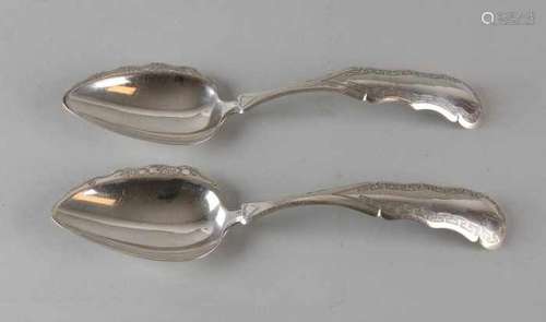 Two silver spoons, 833/000, with a rotated point tray with floral engraving and a stalked handle