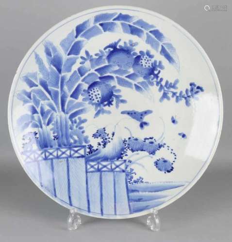 Very large 19th century Japanese porcelain dish with garden decor and butterflies. Dimensions: ø