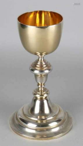 Silver chalice, 833/000, on large round foot and a round gilt chalice. The edge of the foot is