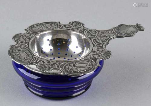 Blue glass drip tray with 835/000 silver top and a silver 835/000 tea strainer with processed edge