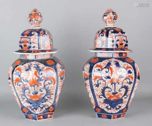 Two large 19th century Japanese six-sided Imari porcelain lid vases with floral and gold decor.