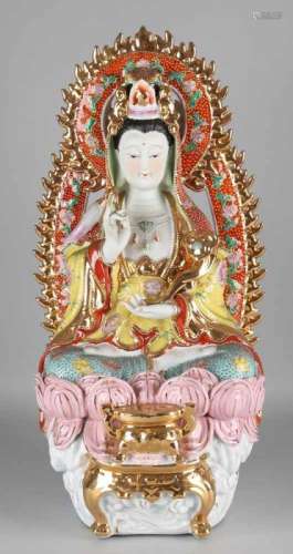 Very large porcelain buddha statue with gilding. Handpainted, sitting on lotus flower. 20th century.