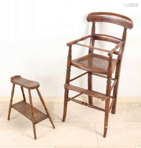 Antique highchair with wickerwork and wooden shoe-step. Circa 1900. Size: 45 - 85 cm. In good