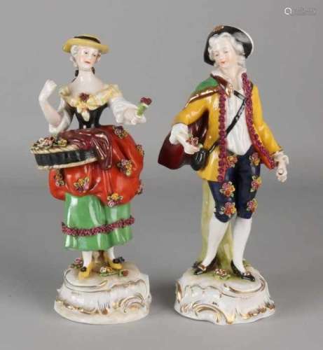 Two antique porcelain figures. Marked with M. Both damaged. Size: 22 - 23 cm. In decent shape.