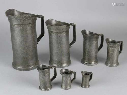 Antique seven-piece pewter gauge set. Circa 1800. Stamps. Size: 5 - 21 cm. In good condition.