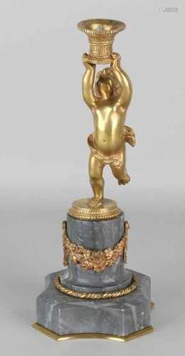 19th Century brass candlestick with putti, on marble basement. Circa 1870. Size: H 25 cm. In good