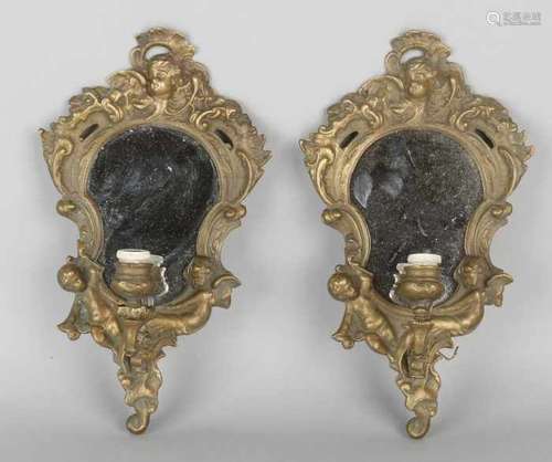 Two bronze wall mirrors with lamp, putti and cherub heads. First half of 20th century. Size: 28 x 14