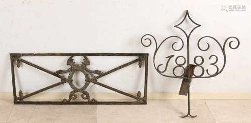 Twice 19th century ironwork. Consisting of: Window with dragon. Wall anchor with year. Size: 97 x 37