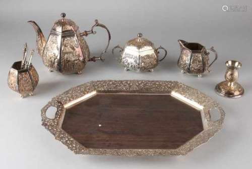 Plated crockery, 4 pieces placed on a tray. Octagonal shaped wooden tray with an openwork plated