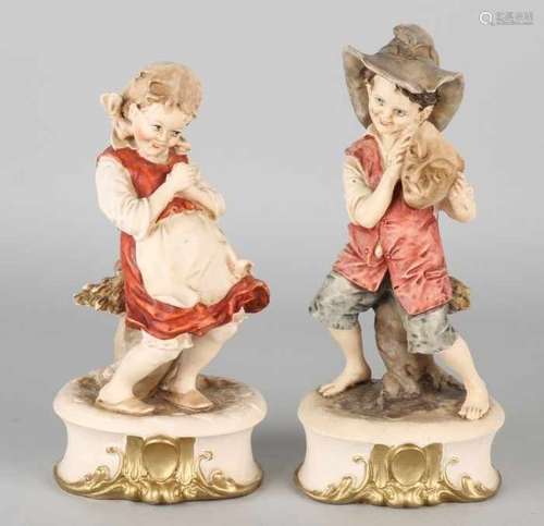 Two decorative Italian figures. Boy and girl. Made of composite. Second half of the 20th century.