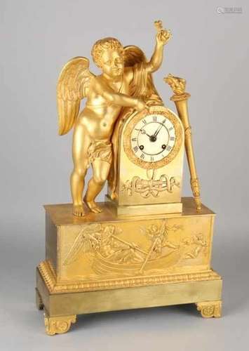 Large fire-gilt bronze Empire pendulum. Circa 1820. Big angel with flower and angel with putti in