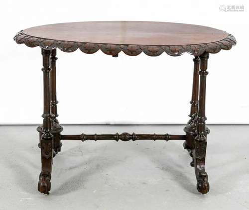 Oval 19th century Louis Philippe table with checked leaves and four-legged paw with spinning tops.