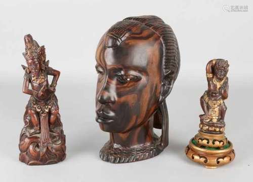 Three times old carving. Among others: African bust, 20th century. Antique krishand and a Balinese