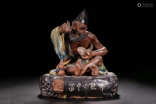 PORCELAIN GLAZED 'JI GONG' SEATED FIGURE