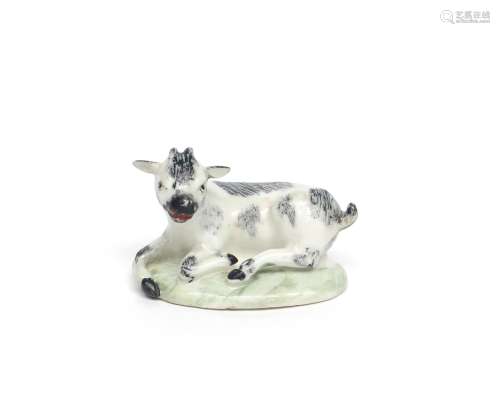 A rare small Bow figure of a goat kid c.1760, recumbent on a low green base, its head turned to