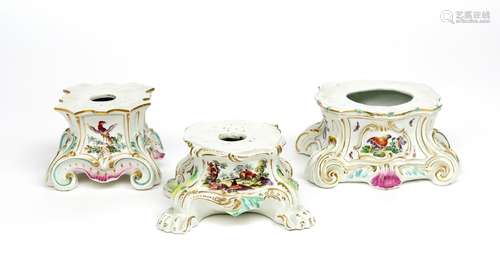 Three Derby figure stands c.1760, one unusually decorated with a landscape panel to one side, a bird